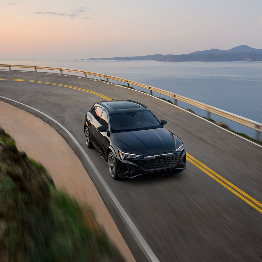 Aerial view of an Audi Q8 e-tron® driving down a road. 