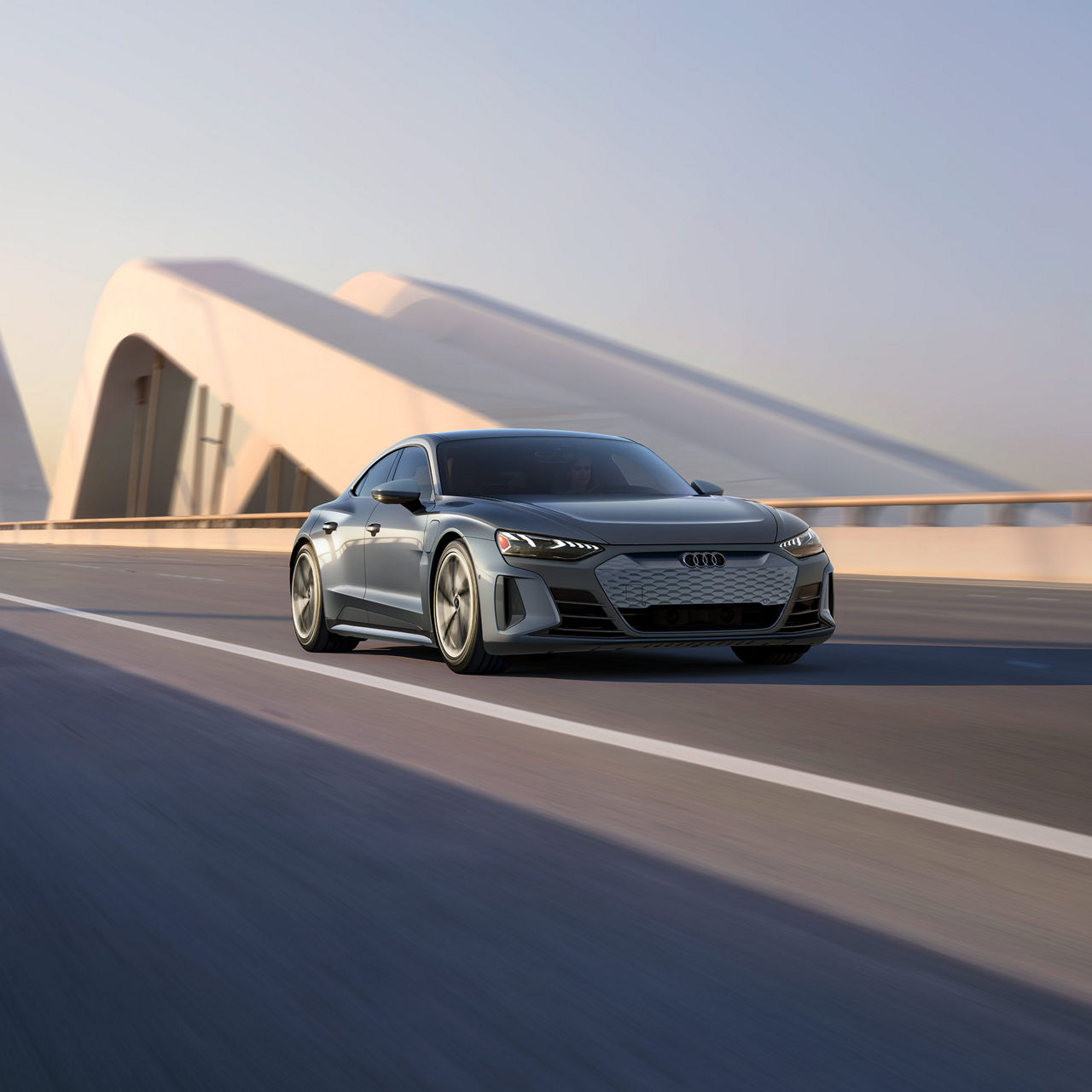 Front profile of an Audi e-tron GT driving.