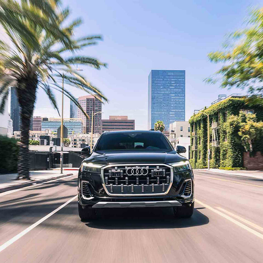 Front profile view of an Audi Q7 accelerating.