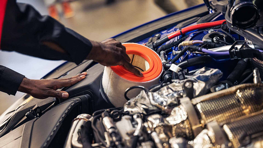 Audi service technician servicing vehicle