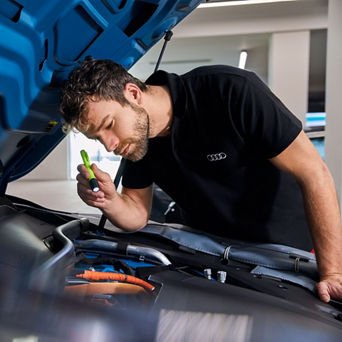 Service technician inspecting vehicle.