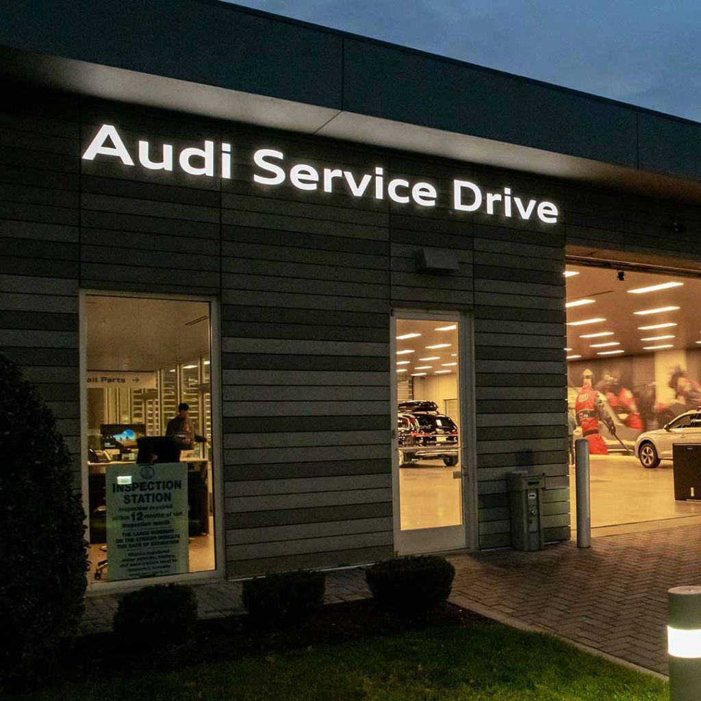 Audi service technician servicing a vehicle.