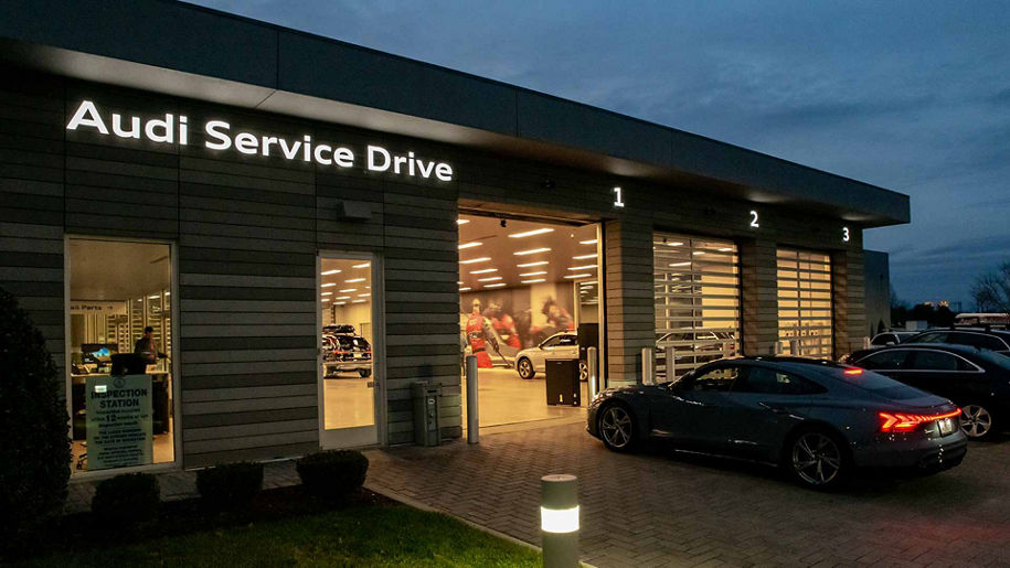 Audi service technician servicing a vehicle.