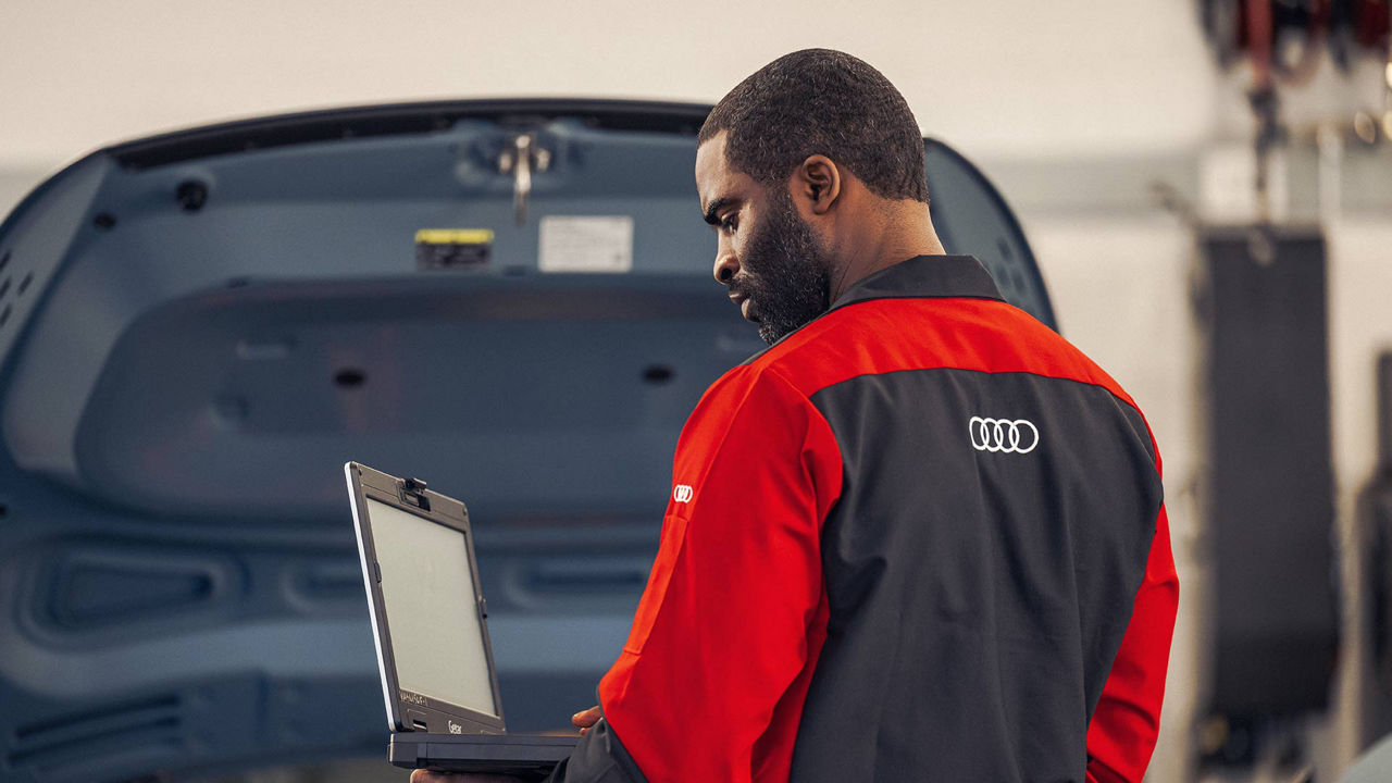 An Audi technician viewing a laptop