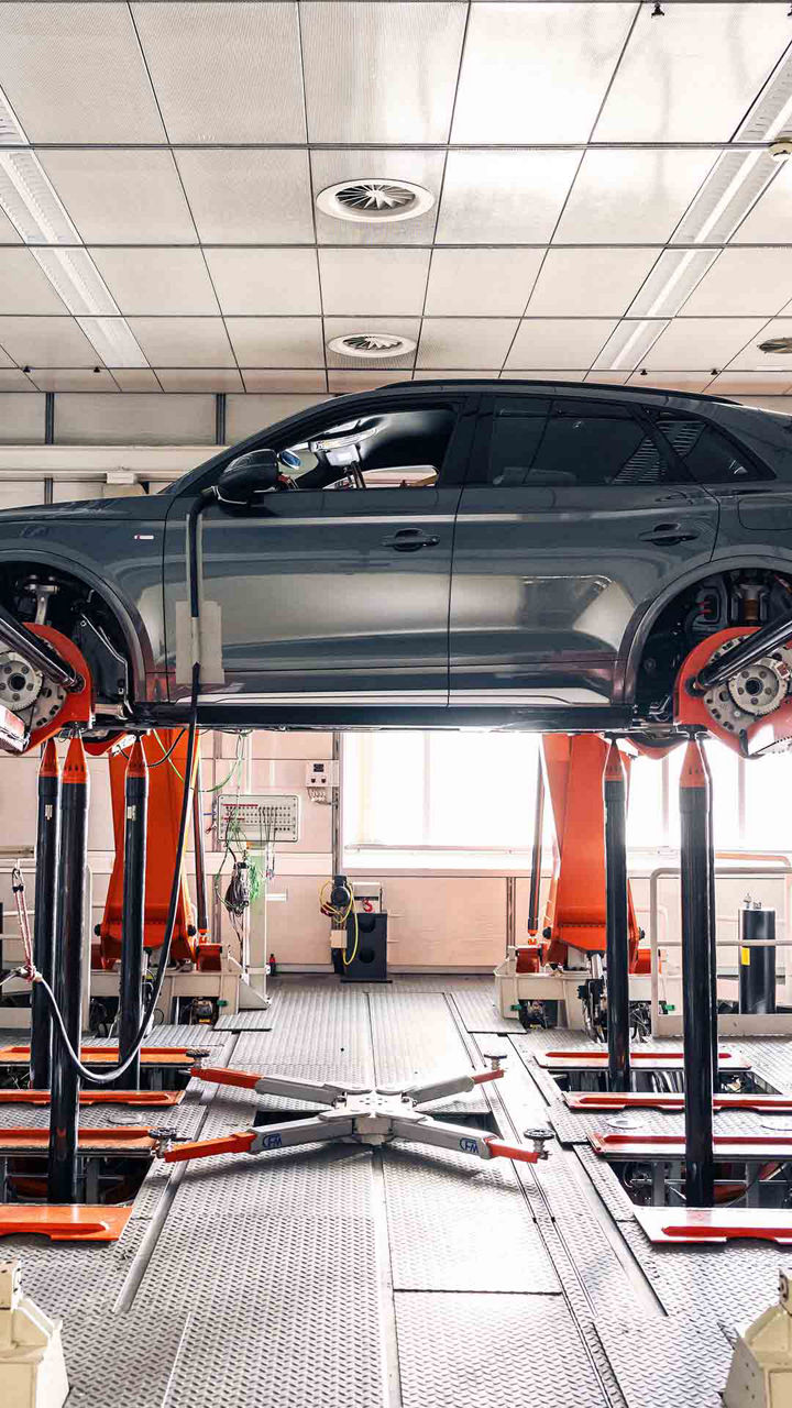 An Audi vehicle getting repaired on the car lift.