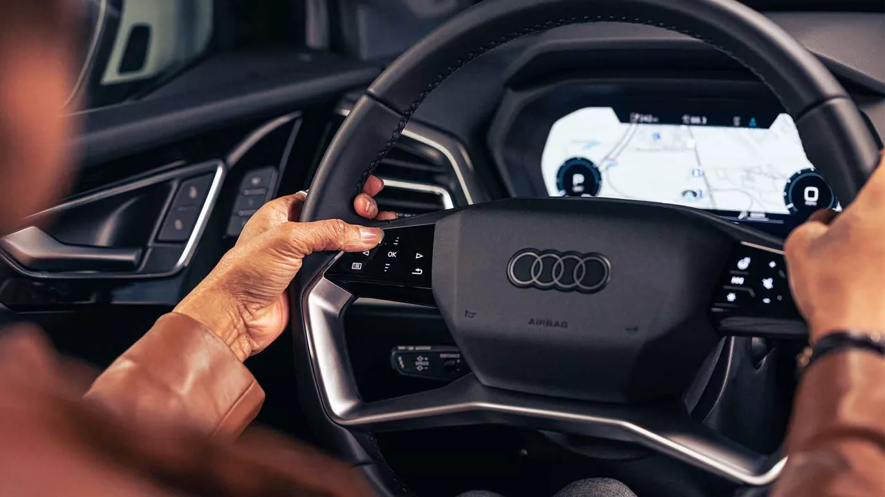 Interior view of an Audi steering wheel and dashboard.