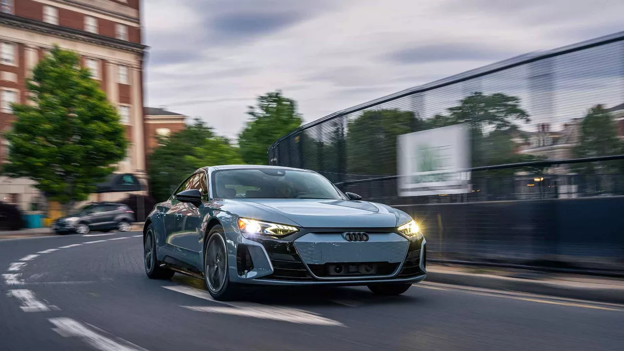 Three-quarter front view of an Audi e-tron GT accelerating. 