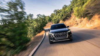 Front facing view of an Audi Q7 accelerating.